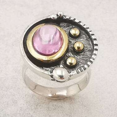 Srebrny artystyczny pierścionek z różowym kamieniem.